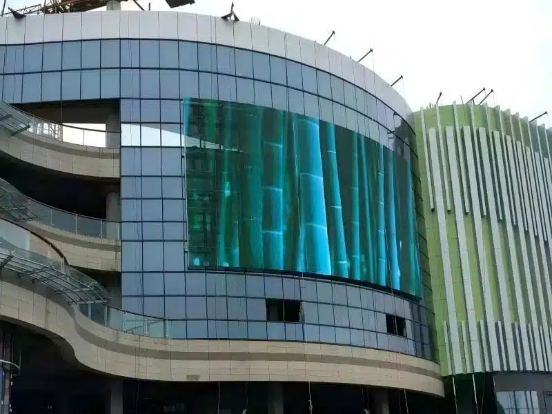 Completed outdoor transparent LED media facade lighting up a shopping mall, transforming the building into a digital landmark.