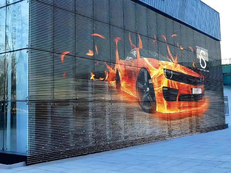 High-transparency outdoor LED mesh display transforming auto 4S shop glass facades into digital advertising billboards.