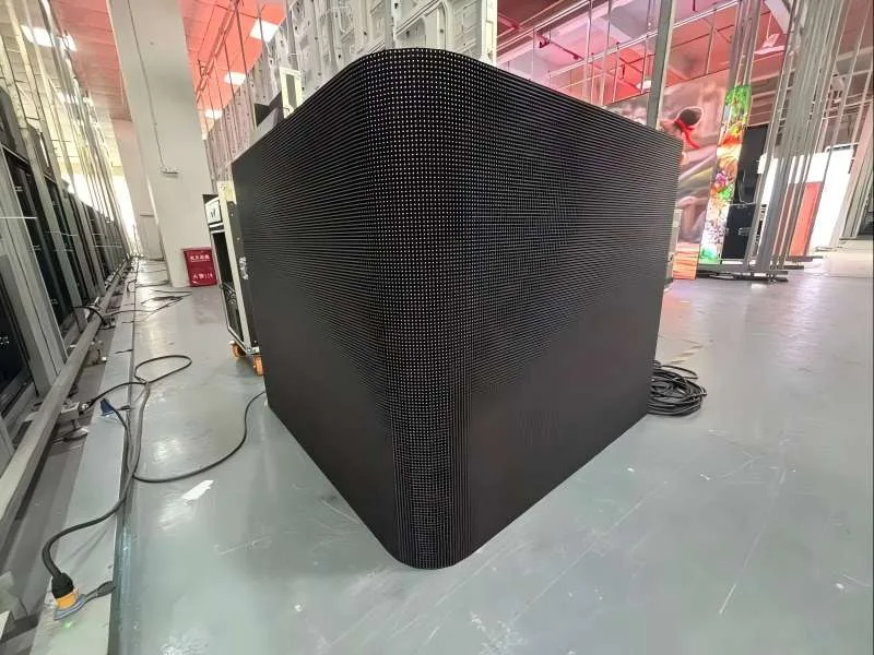 Factory aging test of a creative curved LED display. Features a smooth 90-degree curved corner module that eliminates black seams, creating a perfect L-shape surface for immersive naked-eye 3D visual effects.